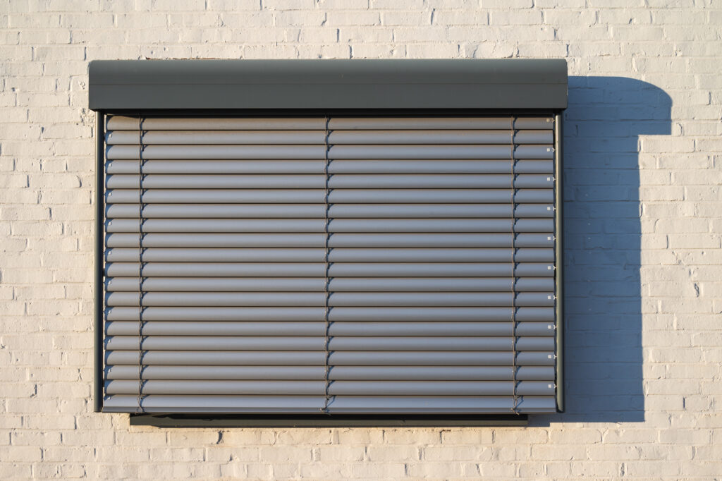 Roll-down metal hurricane shutter
