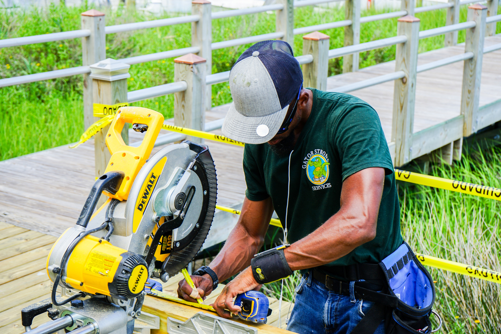 Gator Strong Services employee cutting wood for deck installation