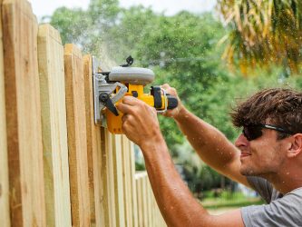 Picture of Gator Strong Services installer preparing a privacy fence for framing.